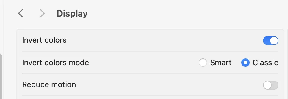 macOS Display Settings showing the Invert Colours toggle option